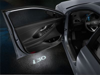 The Hyundai i30 Fastback LED door projectors with the i30 logo projected on the ground.
