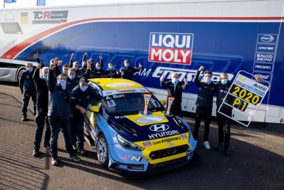 The Hyundai Motorsport’s i30 N TCR in action on a racetrack in a corner.