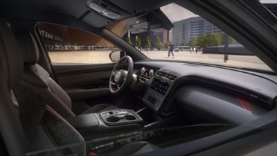 Hyundai TUCSON Hybrid N Line from the front at the river side in a city.