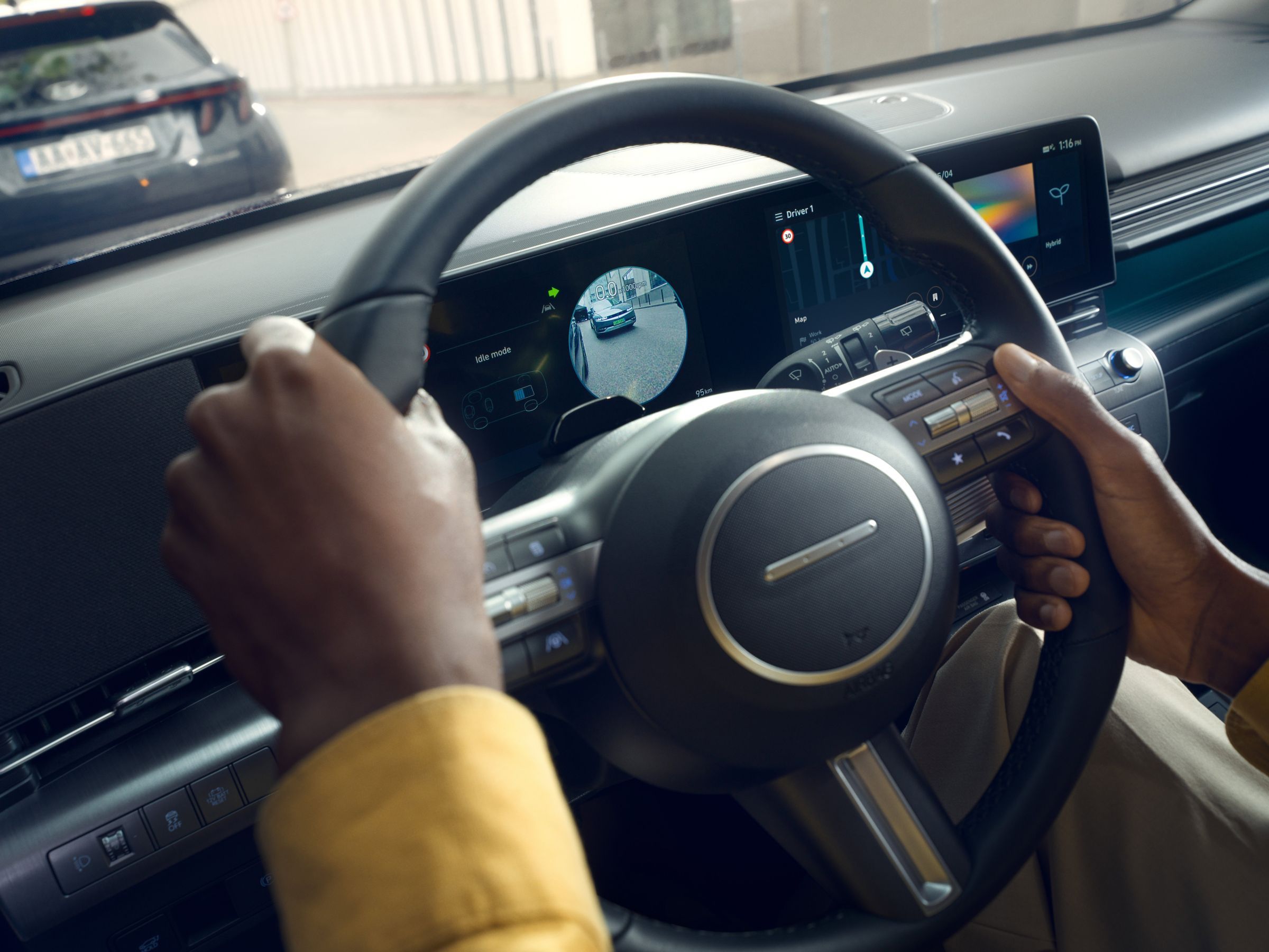 The inside view of the Hyundai KONA with green ambient lighting highlighting the display and the doors.