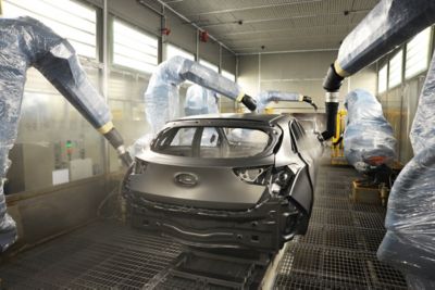 The chassis of a Hyundai electric vehicle getting painted.