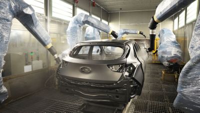 The chassis of a Hyundai electric vehicle getting painted.