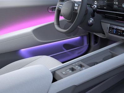 Interiér Hyundai IONIQ 6 s fialovým svetlom na dverách.