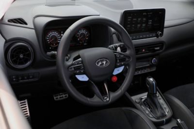 Heated leather steering wheel with the N Grin Shift button inside the Hyundai KONA N hot SUV