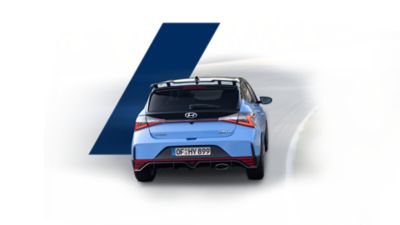 The Hyundai i20 N, seen from the rear, driving a race track.