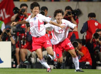 Jisung Park celebrating on the pitch as captain of the South Korean national soccer team.