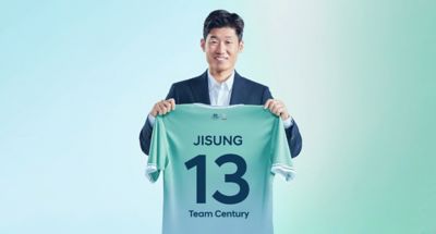 South Korean football legend Jisung Park holding his Hyundai Team Century football jersey.