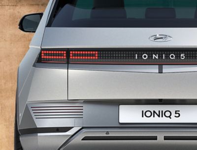 The Hyundai IONIQ 5 electric midsize CUV showing of its backlights and futuristic design.