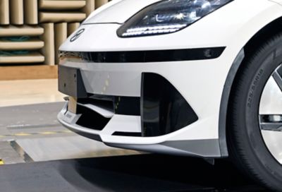 White Hyundai IONIQ 6 in windtunnel testing of active air flap guides