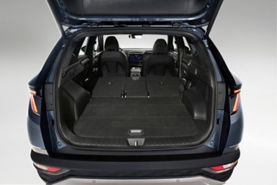 The opened trunk of the Hyundai Tucson compact SUV with the backseats folded down.