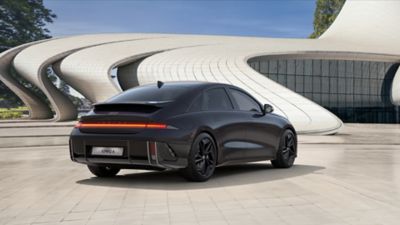 The new all-electric Hyundai IONIQ 6 parked in front of a futuristic building.