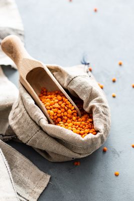 Red lentils and a scoop in a bag.