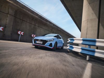 The Hyundai i20 N from the front driving around a corner.