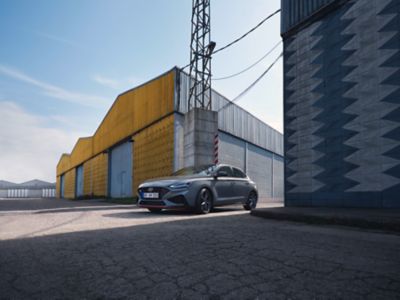 The new Hyundai i30 Fastback N in Performance Blue driving on a racetrack.