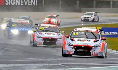 A picture of Hyundai Motorsport’s i30 N TCR in action on a racetrack shown from the front