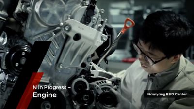 A Hyundai researcher at Namyang R&D Center checking an engine.