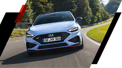 The high-performance Hyundai i30 N speeding down a racetrack with maximum driving fun.