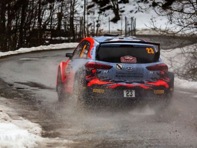 Hyundai Motorsport customer racing rally car i20 R5 in action from the rear.