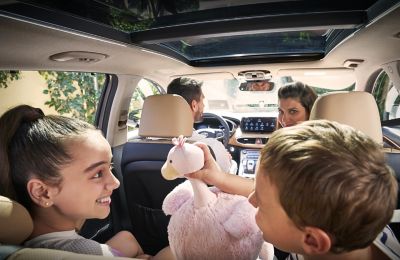 Two children playing in the back of the new Hyundai Santa Fe Plug-in Hybrid 7 seat SUV.
