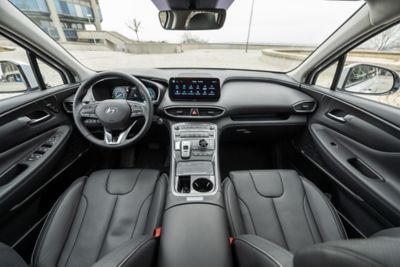 Interior view of the new Hyundai Santa Fe 7 seat SUV showing a man driving down the highway.