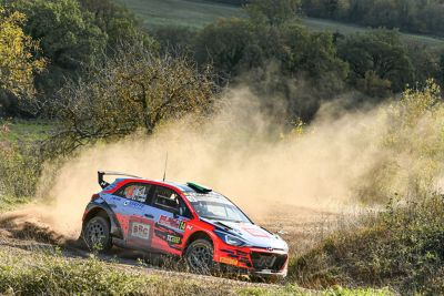 Hyundai Motorsport customer racing rally car i20 R5 in action on a gravel road.