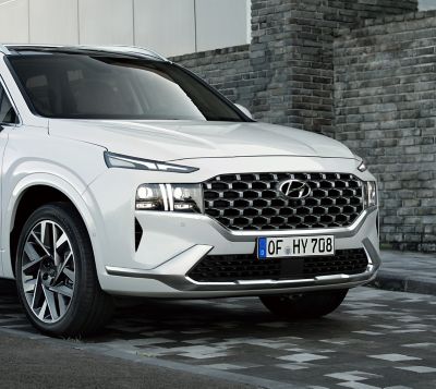 The new Hyundai Santa Fe 7 seat SUV showing its new full LED headlamps and bumper.