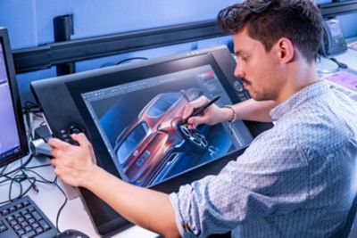 A Hyundai designer drawing the exterior design of the new Hyundai Santa Fe 7 seat SUV.