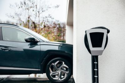 A driver of a Hyundai electric vehicle getting ready to charge his car with his wallbox.