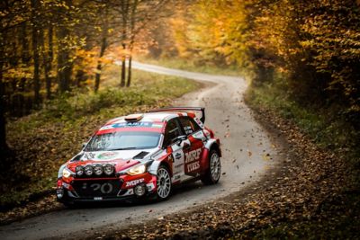 Hyundai Motorsport customer racing rally car i20 R5 in actionon a curvy road.