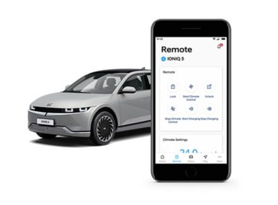Hyundai IONIQ 5 electric vehicle pictured next to a smartphone with the Bluelink app on it.