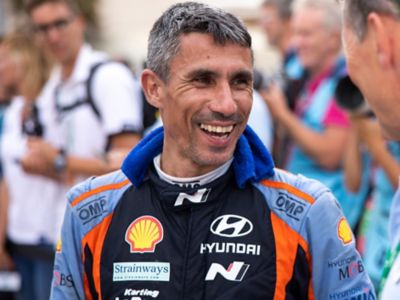 Hyundai WRC motorsport co-driver Cándido Carrera smiling in his race-suit.