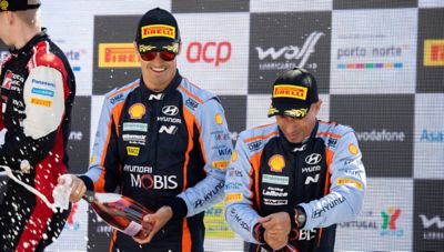 Hyundai Motor WRC driver Dani Sordo and co-driver Cándido Carrera celebrating on the podium.