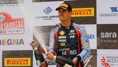Hyundai Motorsport driver Dani Sordo celebrating a win with some champagne.