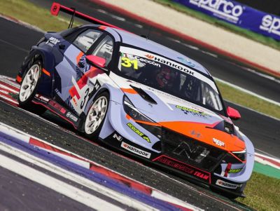 A picture of Hyundai Motorsport customer racing Elantra N TCR in action on a racetrack shown from the side