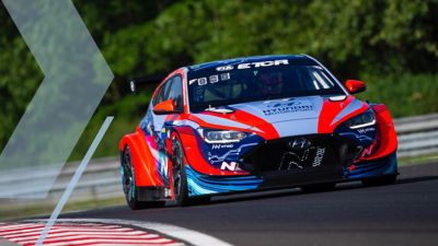Hyundai Elantra N TCR driving on a race track shown from the front.
