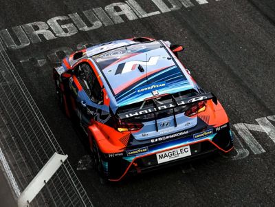 Hyundai Elantra N TCR driving on a race track shown from above.