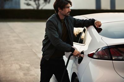 A man charging his Hyundai IONIQ.