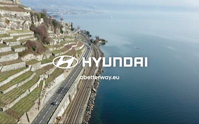 The Hyundai logo in front of a beautiful coast.