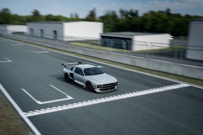 Hyundai N Vision 74 concept car crossing the finish line of a racetrack.