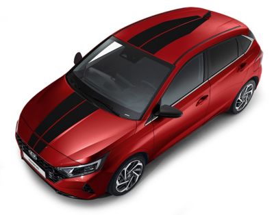 The Hyundai i20 in tomato red and racing stripes for the bonnet and roof.