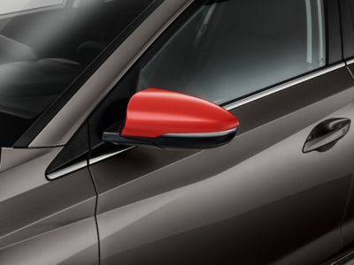 Door mirror caps on a Hyundai i20 in tomato red.