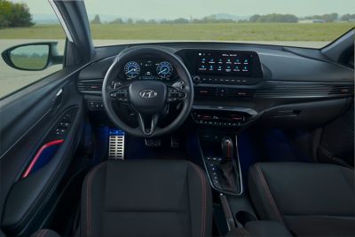 A wide-angle view of the Hyundai i20 N Line's interior, showing the distinct red colour accents.