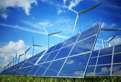 Solar panels and wind turbines on a field.