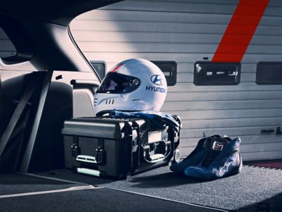 Track-racing protective gear in the trunk of an Hyundai Kona N.	