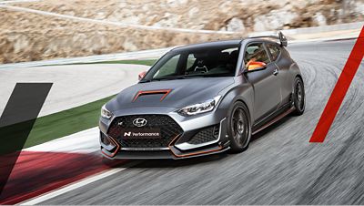 The Hyundai Veloster N ETCR High-Performance EV in action on the racetrack.