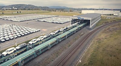 Hyundai cars are loaded on a train for delivery.