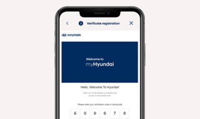 A man on a sofa completing his profile to experience the services of the myHyundai app.