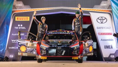 Hyundai Motorsport driver Oliver Solberg and Elliott Edmondson celebrating their rally race car.