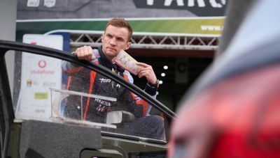 Hyundai co-driver Martin Järveoja leaning on the cardoor.