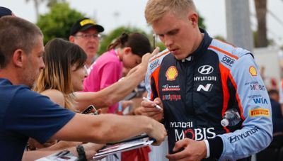 Hyundai Motorsport driver Ott Tänak giving autographs after a race.